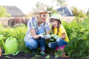 Mother and daughter planting in the garden