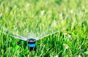 Sprinkler system watering lawn in the spring