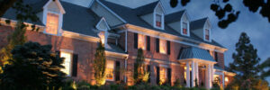 Landscape lighting illuminating a house in the evening.